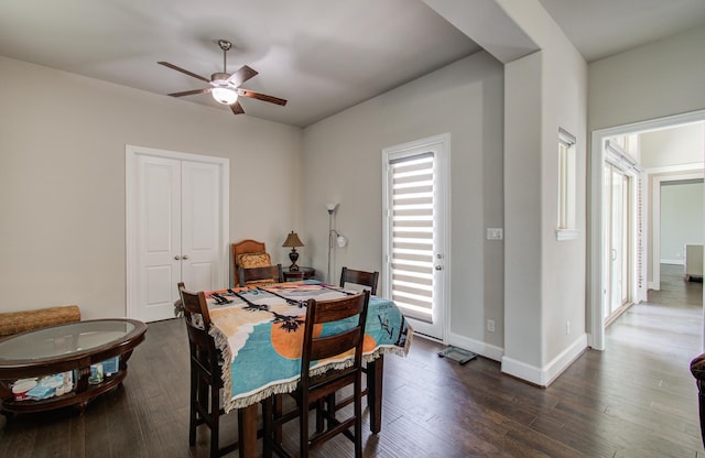 dining area featuring dark wood-style flooring, baseboards, and a ceiling fan