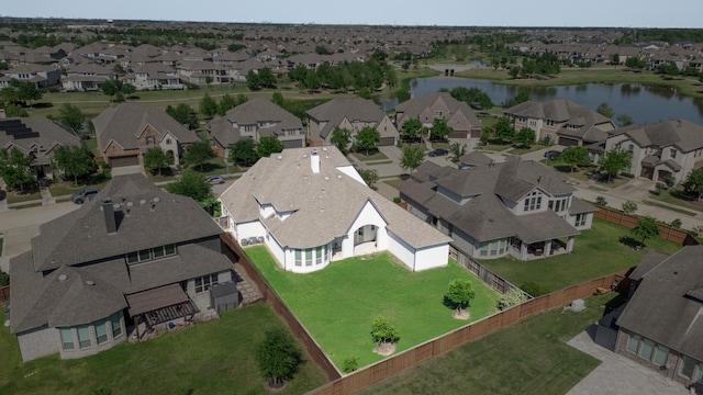 birds eye view of property with a water view and a residential view