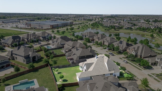 drone / aerial view featuring a water view and a residential view