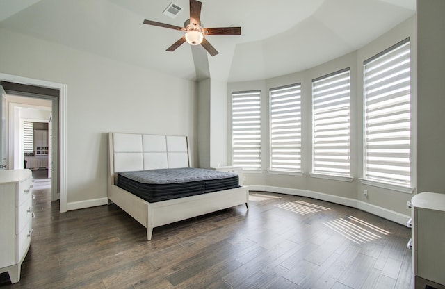 bedroom with a ceiling fan, baseboards, dark wood finished floors, and visible vents