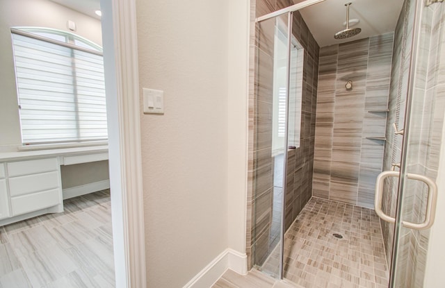bathroom featuring baseboards and a stall shower