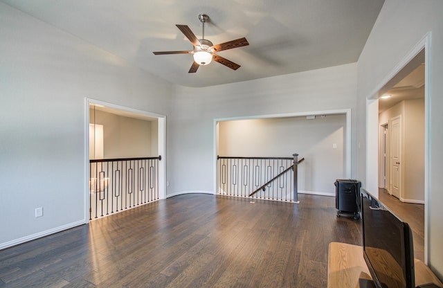 spare room with ceiling fan, wood finished floors, and baseboards
