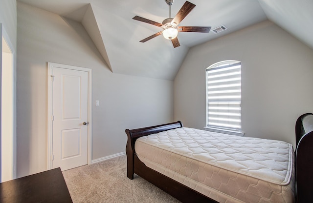bedroom featuring visible vents, a ceiling fan, light colored carpet, and lofted ceiling
