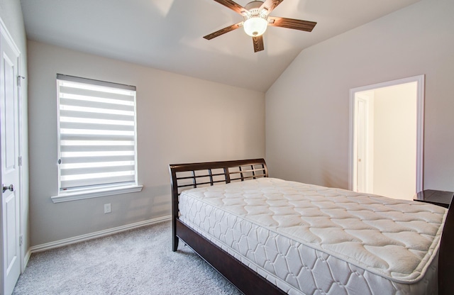 bedroom with carpet flooring, baseboards, vaulted ceiling, and ceiling fan