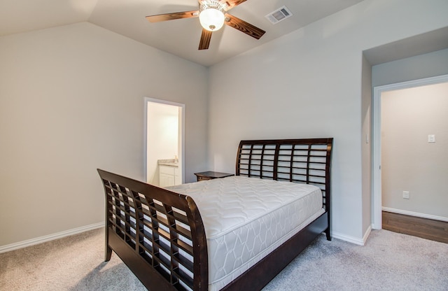 carpeted bedroom with visible vents, baseboards, ceiling fan, connected bathroom, and vaulted ceiling