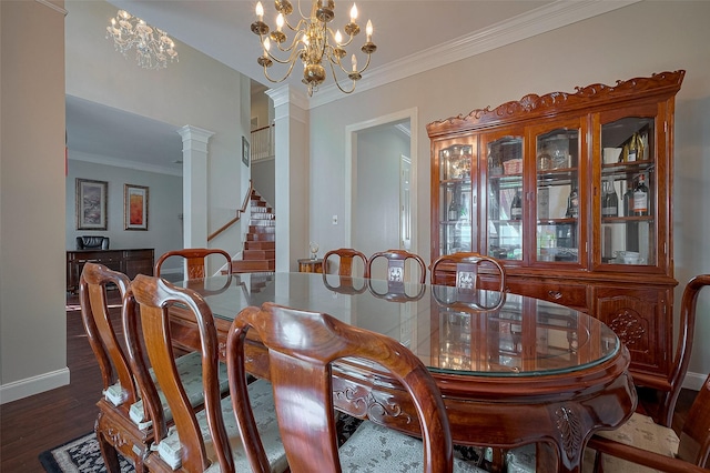 dining area featuring crown molding, baseboards, wood finished floors, and stairs
