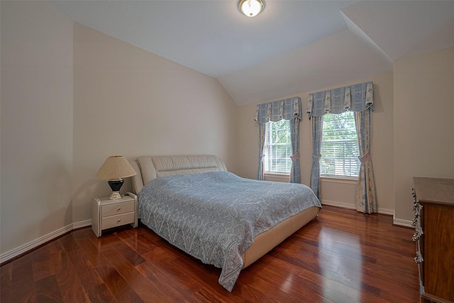 bedroom featuring dark wood finished floors, baseboards, and lofted ceiling