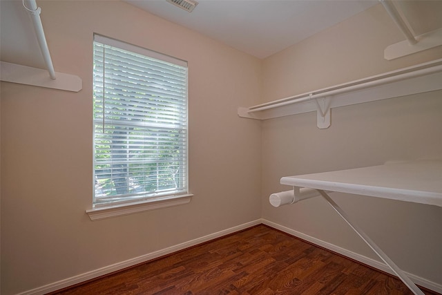 walk in closet featuring visible vents and wood finished floors