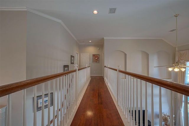 corridor featuring baseboards, recessed lighting, crown molding, visible vents, and wood-type flooring