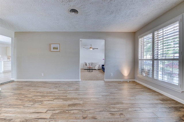 4103 Donna Lynn Dr, Houston, TX 77092 - spare room featuring baseboards, a textured ceiling, visible vents, ceiling fan, and wood finished floors