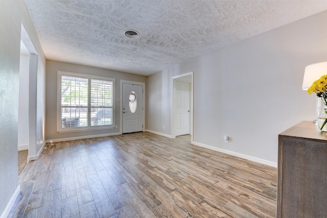 4103 Donna Lynn Dr, Houston, TX 77092 - foyer entrance with a textured ceiling, wood finished floors, baseboards, and visible vents