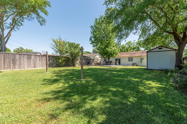 4103 Donna Lynn Dr, Houston, TX 77092 - view of yard with a patio area, a fenced backyard, an outdoor structure, and a storage unit
