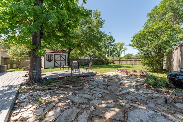 4103 Donna Lynn Dr, Houston, TX 77092 - view of yard featuring a patio area, a fenced backyard, an outdoor structure, a storage unit, and a wooden deck