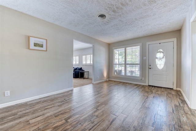 4103 Donna Lynn Dr, Houston, TX 77092 - entryway with a textured ceiling, wood finished floors, baseboards, and visible vents