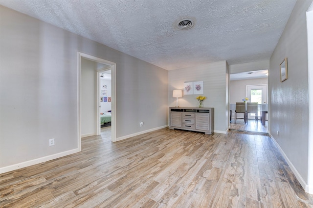4103 Donna Lynn Dr, Houston, TX 77092 - empty room with a textured ceiling, wood finished floors, baseboards, and visible vents