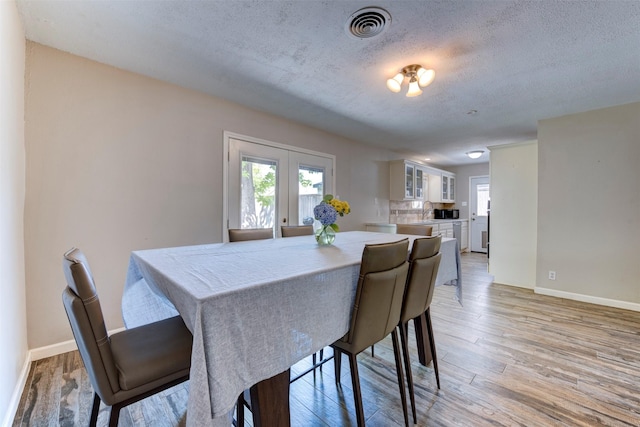 4103 Donna Lynn Dr, Houston, TX 77092 - dining room featuring light wood-style floors, plenty of natural light, visible vents, and baseboards