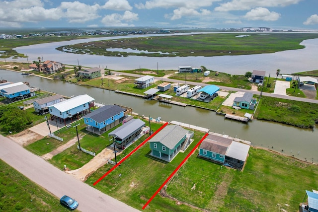 birds eye view of property with a water view and a residential view