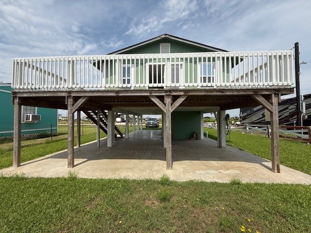 exterior space featuring a patio, a yard, a deck, and a carport