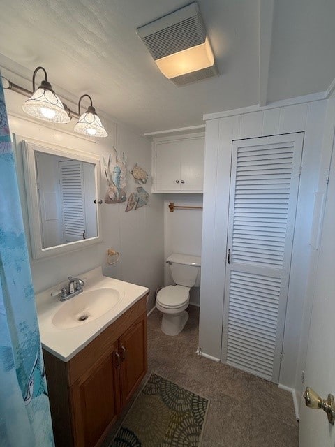 full bath featuring vanity and toilet