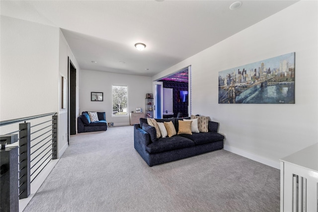 living area featuring light colored carpet and baseboards