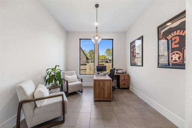 office space with light tile patterned floors and baseboards