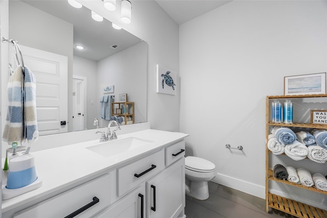bathroom with visible vents, toilet, vanity, and baseboards