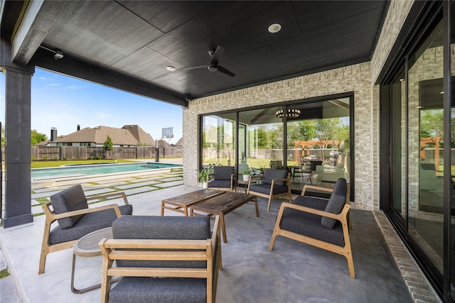view of patio / terrace featuring a fenced in pool, an outdoor living space, a fenced backyard, and ceiling fan