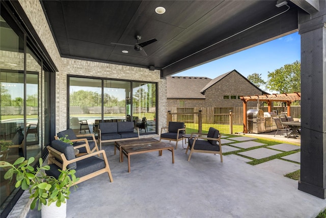 view of patio / terrace with an outdoor living space, fence, and ceiling fan