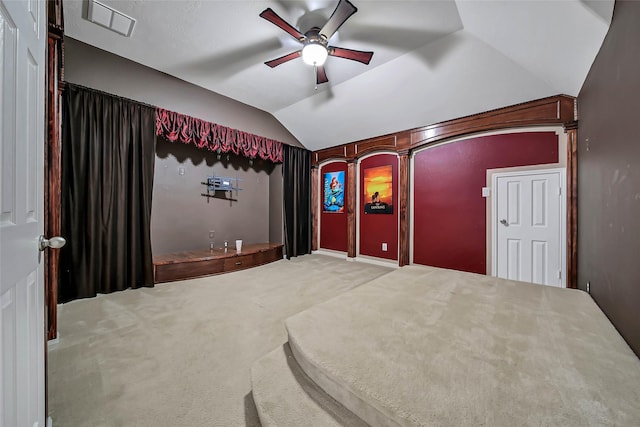 home theater with visible vents, ceiling fan, carpet flooring, and lofted ceiling
