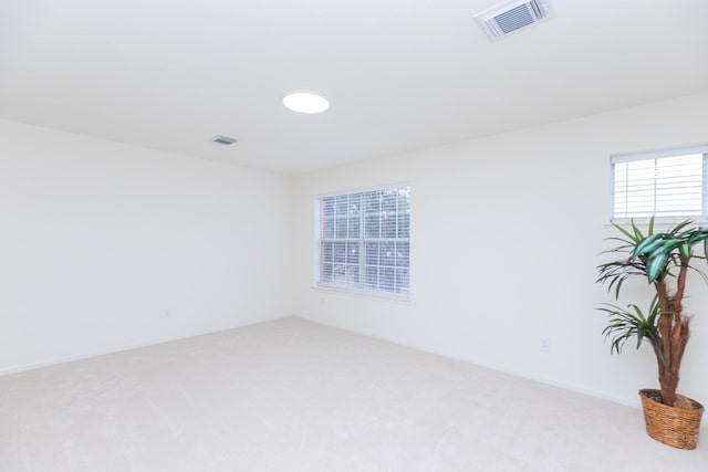 carpeted spare room with visible vents