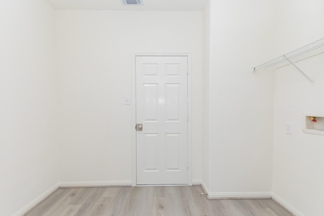 clothes washing area featuring visible vents, baseboards, light wood-type flooring, laundry area, and hookup for a washing machine