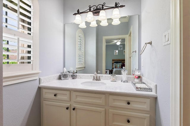 bathroom with vanity, ensuite bath, and a ceiling fan