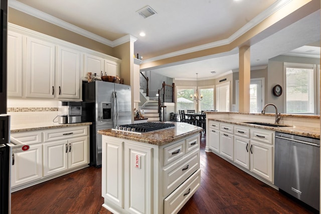 kitchen with white cabinets, appliances with stainless steel finishes, a sink, and visible vents