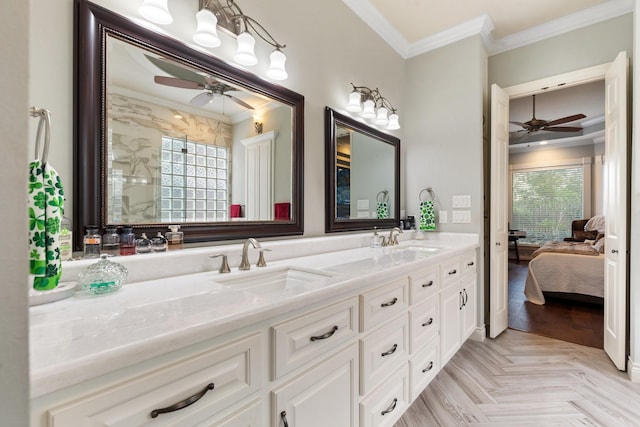 ensuite bathroom featuring a sink, ornamental molding, and ceiling fan