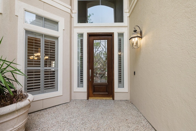 property entrance with stucco siding