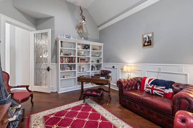 living area with wainscoting, vaulted ceiling, crown molding, and wood finished floors