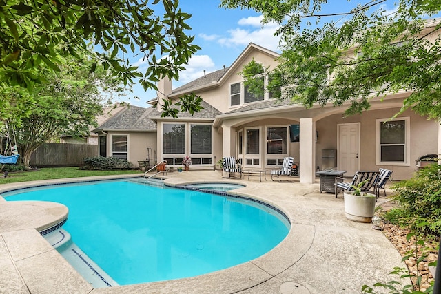 view of pool featuring fence, an in ground hot tub, a fenced in pool, and a patio