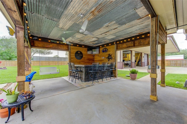 view of patio featuring fence and outdoor dry bar