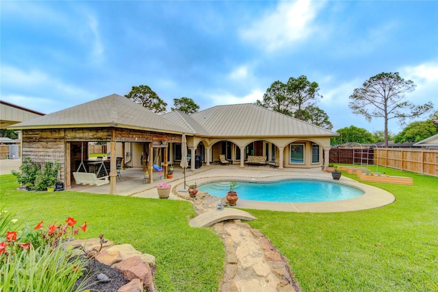 view of pool with a yard, a patio area, a fenced in pool, and fence