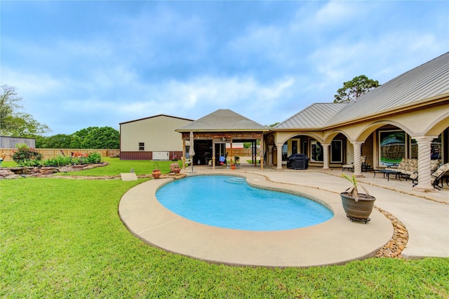 view of swimming pool featuring a fenced in pool, a patio, a yard, and fence