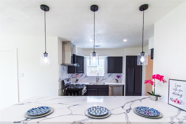 kitchen with wall chimney range hood, light stone counters, stainless steel appliances, and recessed lighting