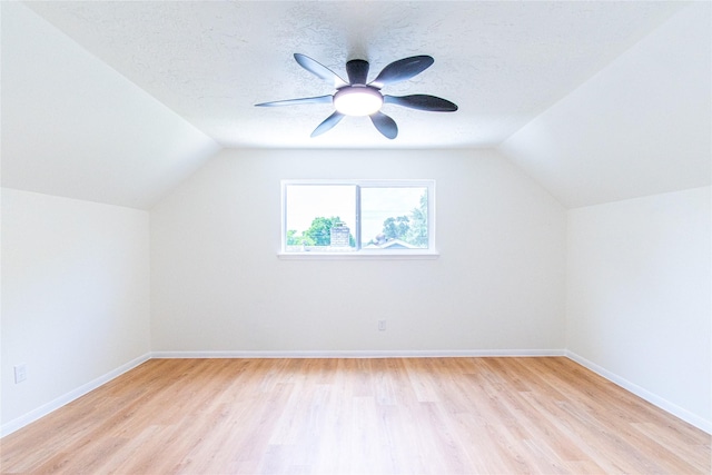 bonus room featuring baseboards, vaulted ceiling, and light wood-type flooring