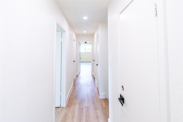 corridor featuring recessed lighting, baseboards, and light wood-style flooring