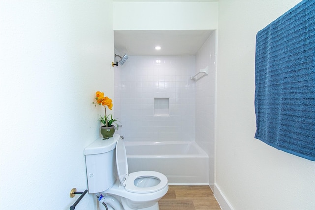 full bath featuring shower / bathtub combination, wood finished floors, and toilet