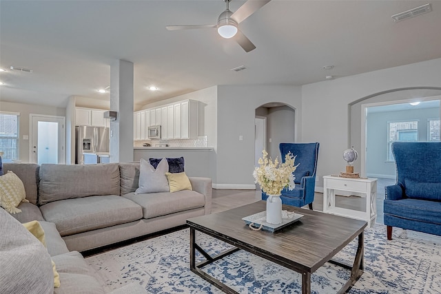 26626 Yukon Straight Dr, Richmond, TX 77406 - living room with arched walkways, visible vents, and a ceiling fan