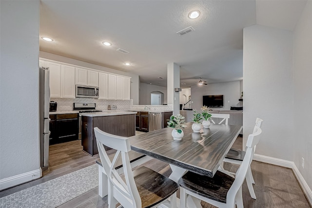 26626 Yukon Straight Dr, Richmond, TX 77406 - dining room featuring visible vents, light wood-type flooring, baseboards, and ceiling fan