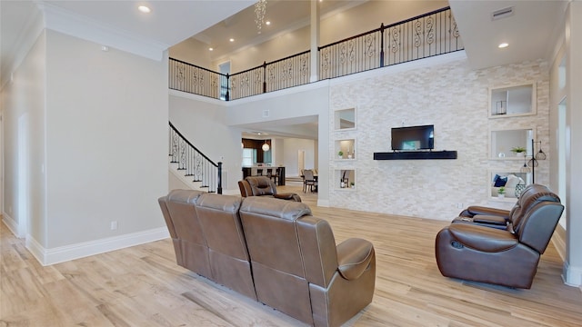 living room with baseboards, visible vents, wood finished floors, and stairway