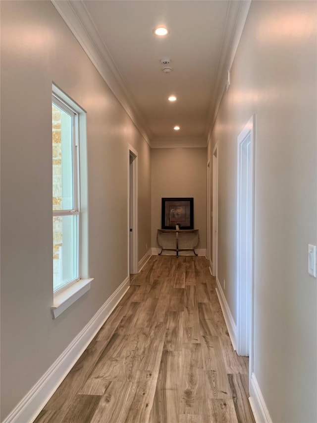 hall featuring crown molding, recessed lighting, and a wealth of natural light