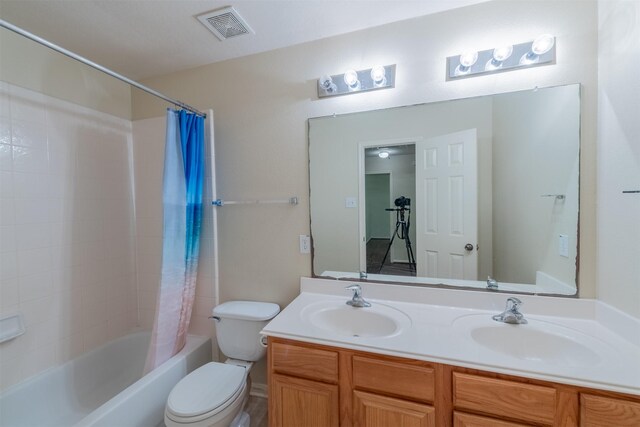 full bathroom featuring a sink, visible vents, toilet, and shower / bathtub combination with curtain