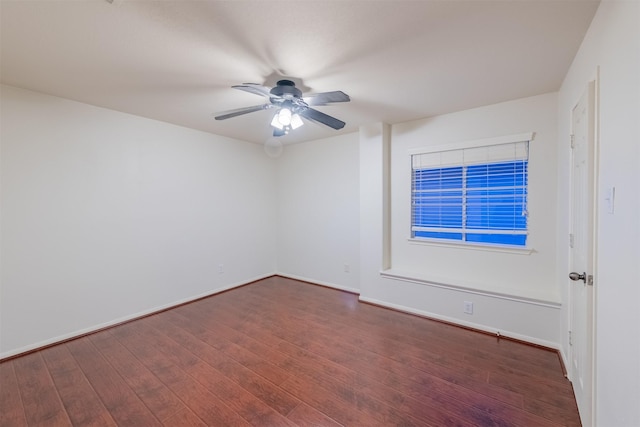 empty room featuring baseboards, a ceiling fan, and wood finished floors